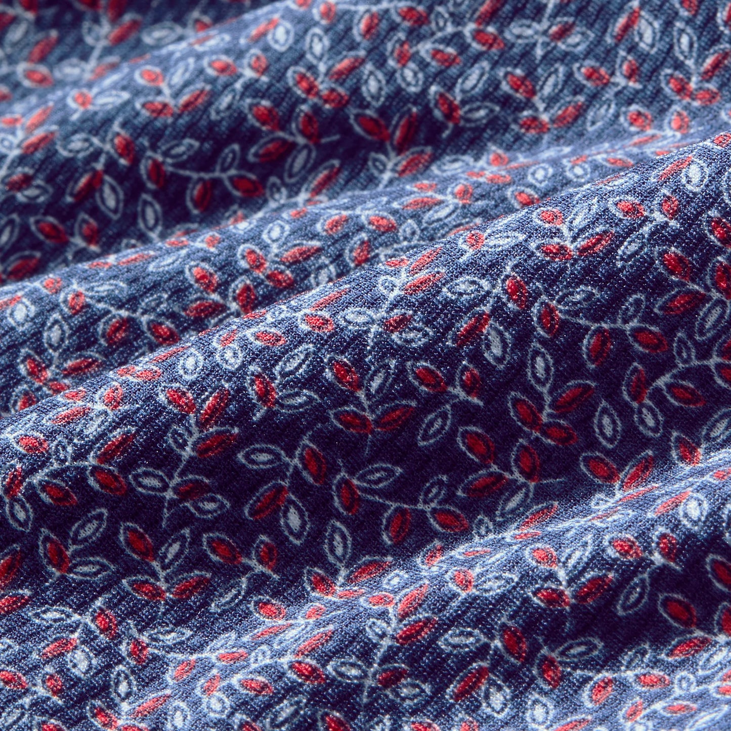 Mizzen + Main Halyard short sleeve shirt fabric with navy background and red and white leaf pattern