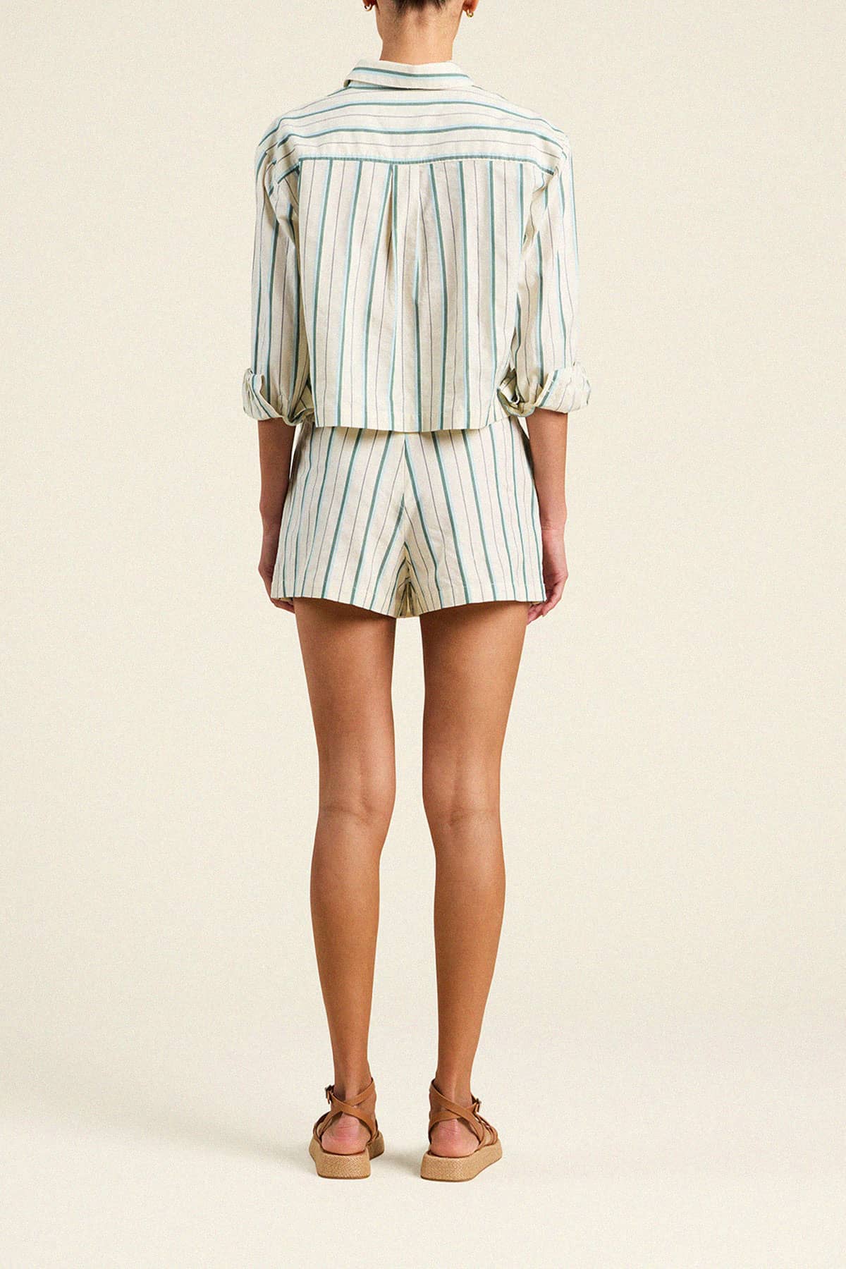 Back view of woman wearing Trovata Gracia striped skort with matching button-up shirt and platform sandals