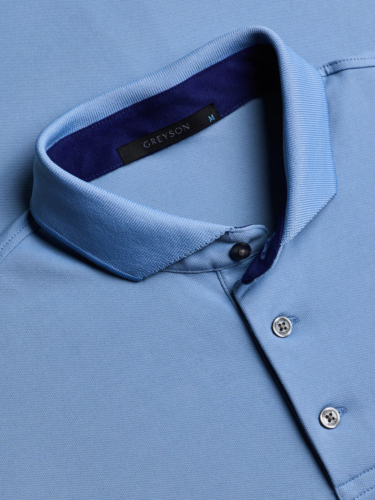Greyson Crowley Icon Polo shirt showing collar detail with button placket and brand label