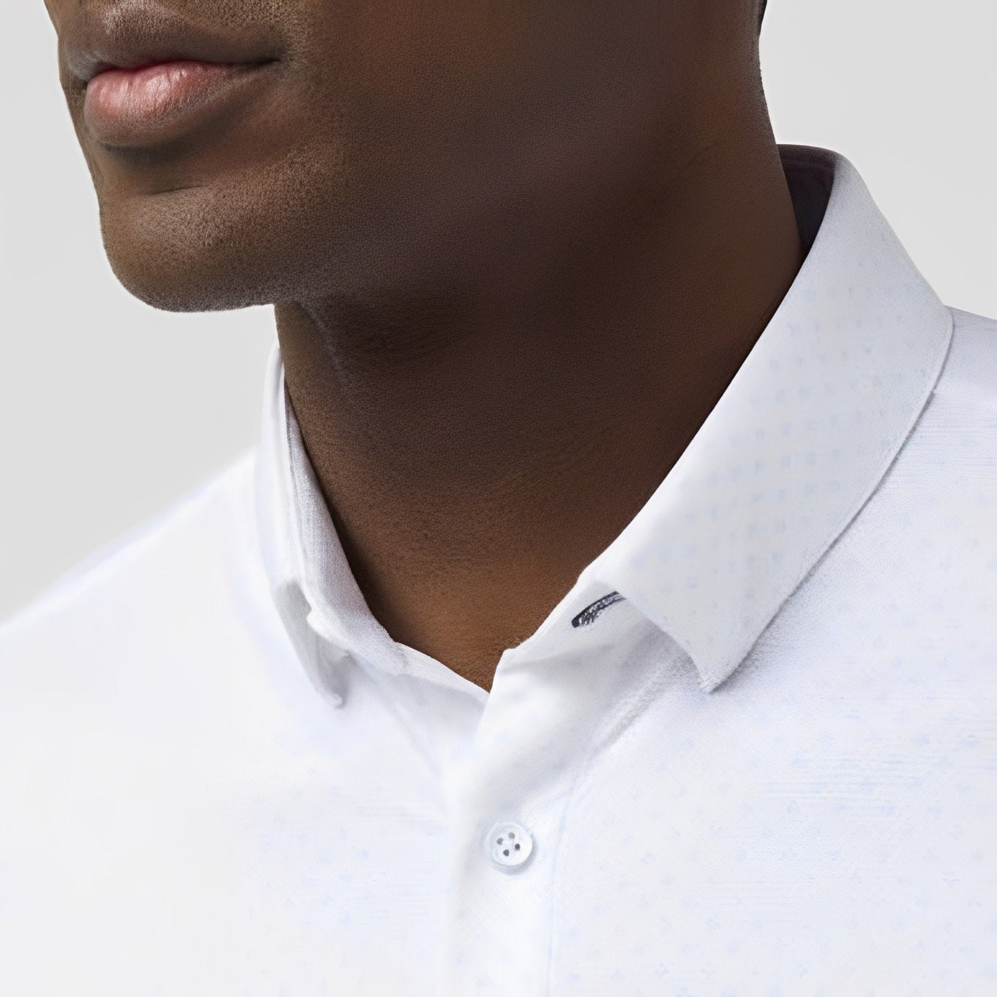 Close-up of man wearing white short sleeve dress shirt with collar detail