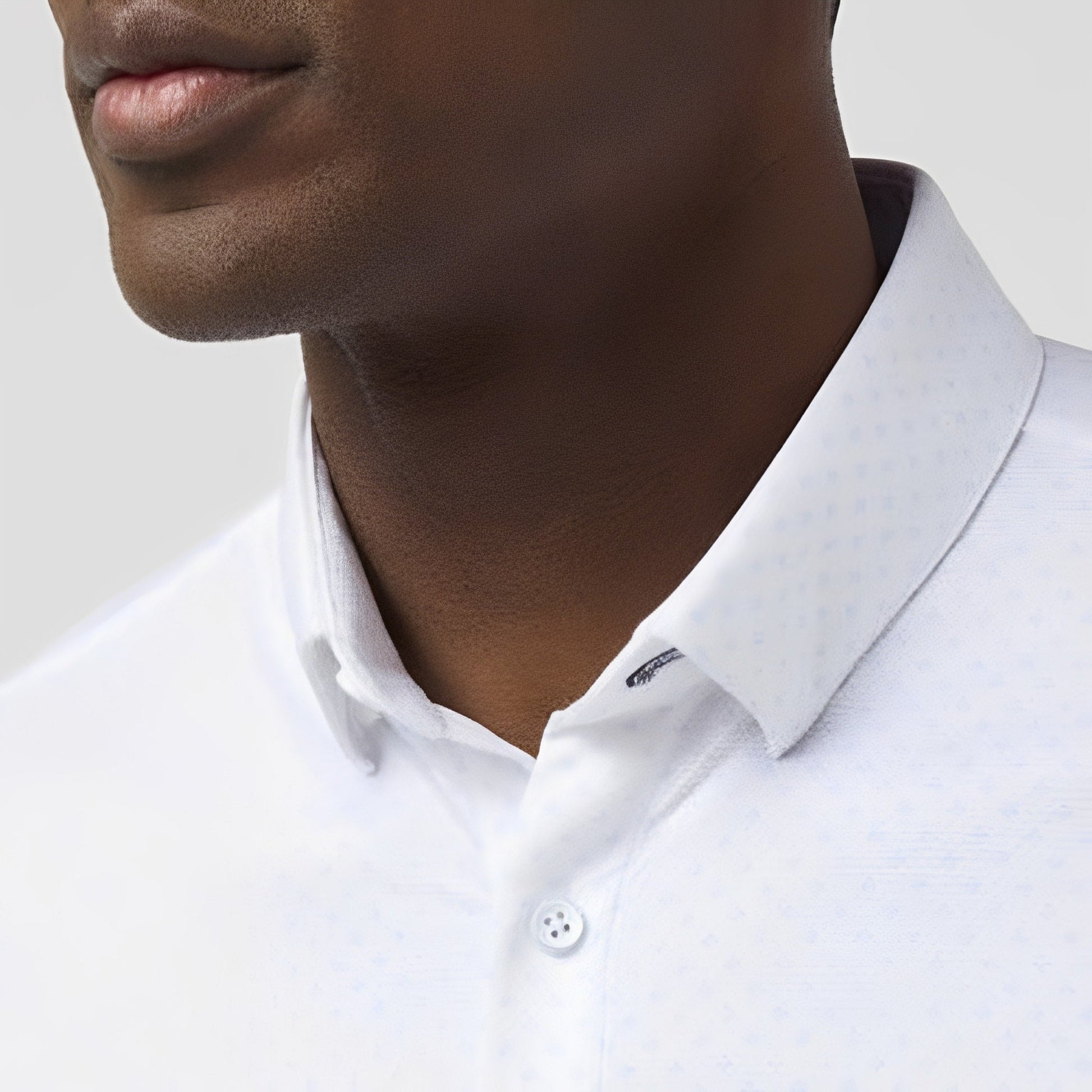 Close-up of man wearing white short sleeve dress shirt with collar detail