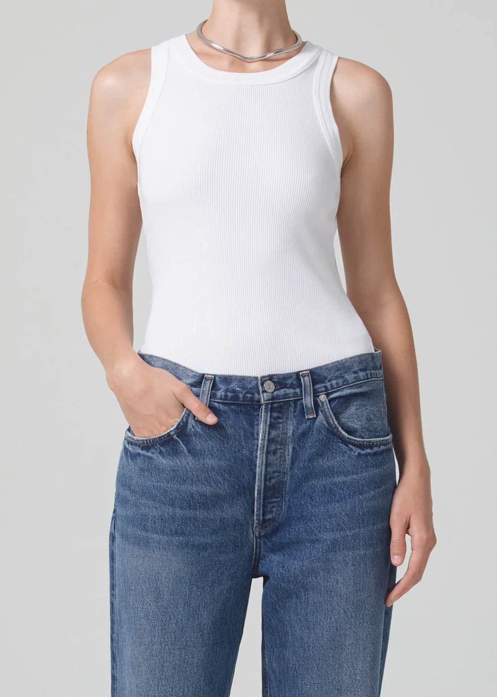 Citizens of Humanity Isabel white ribbed sleeveless tank top worn with blue jeans and silver necklace.